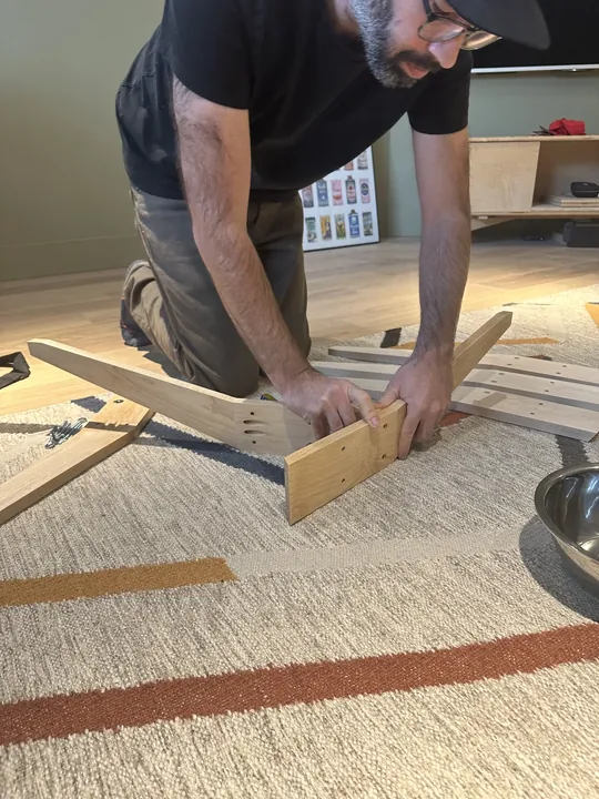 Jeremy fitting together the maple legs of a Triangle Stand.